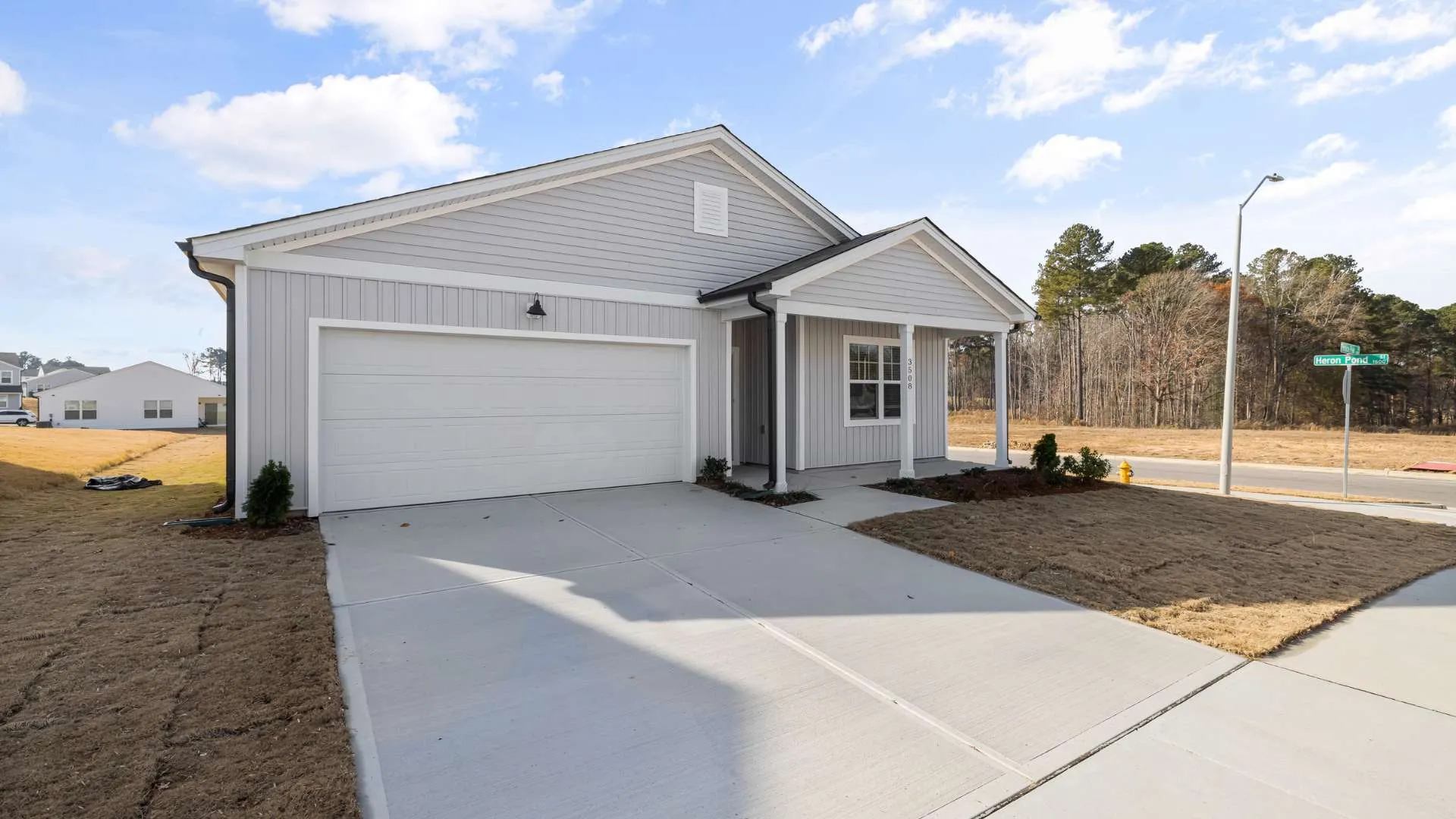 Clean, sealed concrete driveway in front of a Colorado home