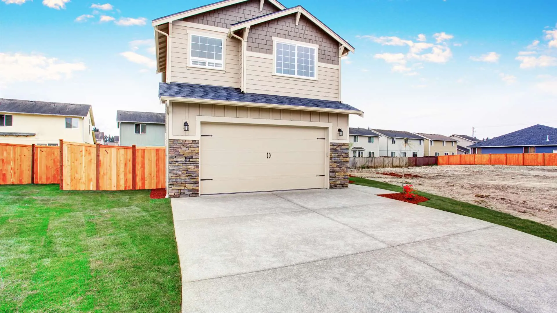 Clean, sealed concrete driveway in front of a Colorado home