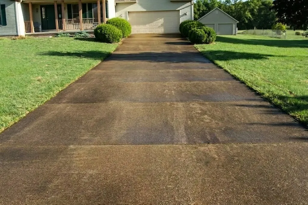 A stained, worn driveway before resurfacing